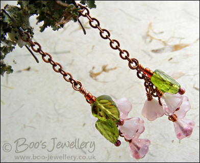Chain earrings with pink glass blossoms on rosy red copper
