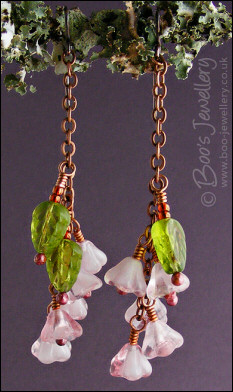 Chain earrings with pink glass blossoms on rosy red copper