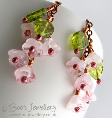 Chain earrings with pink glass blossoms on rosy red copper
