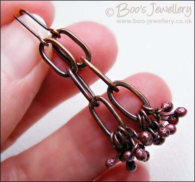 Antiqued copper long link earrings with rosy copper buds