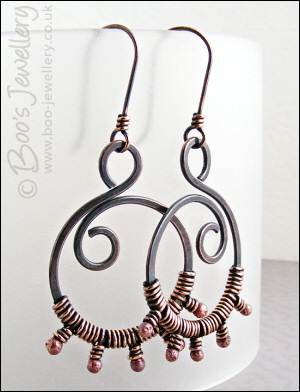 Oxidised copper swirl earrings wrapped with rosy copper buds