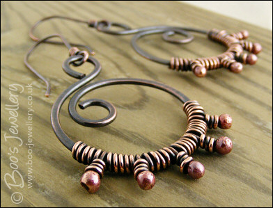 Oxidised copper swirl earrings wrapped with rosy copper buds