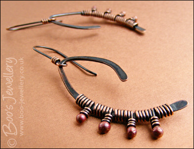 Asymmetric copper wishbone earrings with rosy copper buds