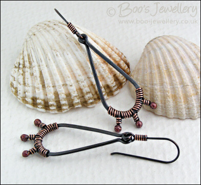 Long dark teardrop earrings with rosy buds