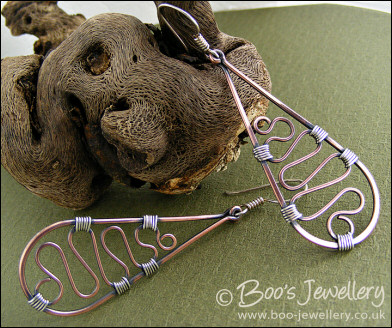 Teardrop earrings filled with squiggles wrapped with silver