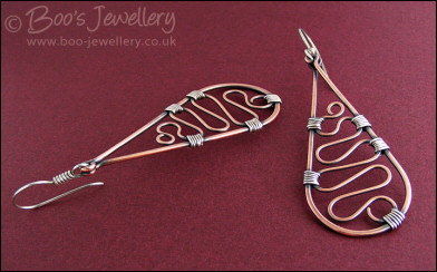 Teardrop earrings filled with squiggles wrapped with silver