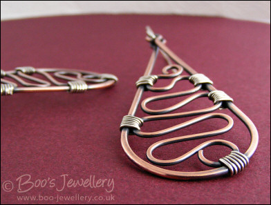 Teardrop earrings filled with squiggles wrapped with silver