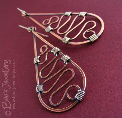 Teardrop earrings filled with squiggles wrapped with silver