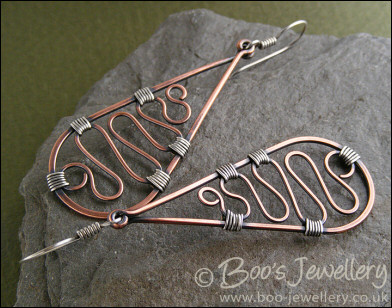 Teardrop earrings filled with squiggles wrapped with silver