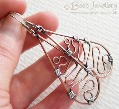 Teardrop earrings filled with squiggles wrapped with silver