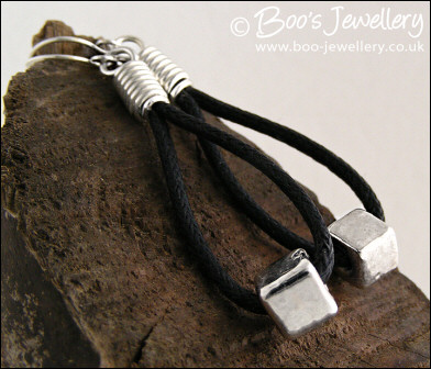 Greek silver cubes on cotton