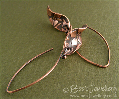 Antiqued copper earrings with flower charms and long feature earwires