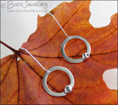Silver circle earrings with solid pebbles of silver