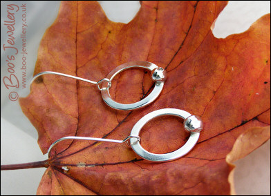Silver circle earrings with solid pebbles of silver