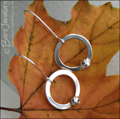 Silver circle earrings with solid pebbles of silver