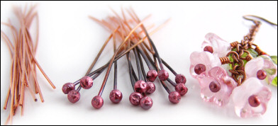 Chain earrings with pink glass blossoms on rosy red copper