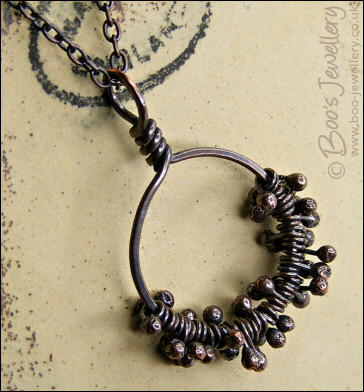 Necklace featuring dark clusters of molten copper
