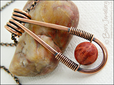 Teardrop shaped antiqued copper and red coral pendant