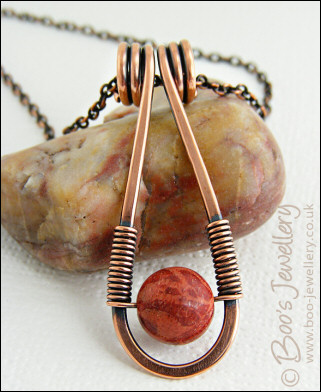 Teardrop shaped antiqued copper and red coral pendant