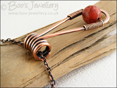 Teardrop shaped antiqued copper and red coral pendant