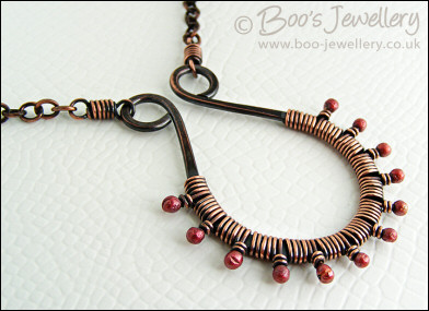 Antiqued copper scroll necklace wrapped with rosy buds