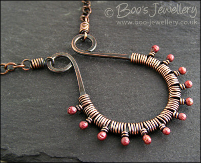 Antiqued copper scroll necklace wrapped with rosy buds