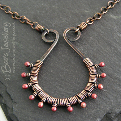 Antiqued copper scroll necklace wrapped with rosy buds