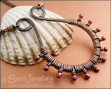 Antiqued copper scroll necklace wrapped with rosy buds