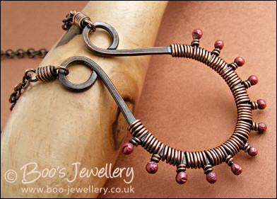 Antiqued copper scroll necklace wrapped with rosy buds