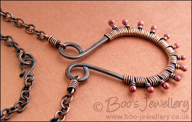Antiqued copper scroll necklace wrapped with rosy buds