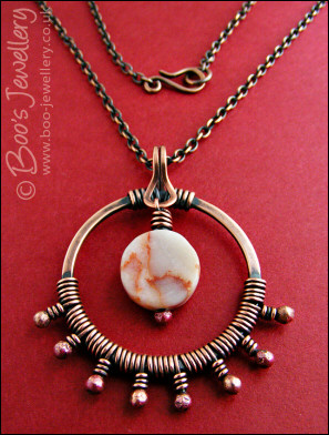 Antiqued copper circle pendant, bud wrapped and with spider web jasper