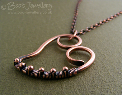 Curly antiqued copper heart wrapped with beads