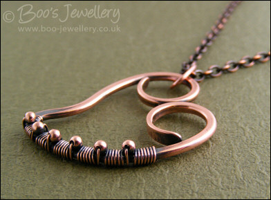 Curly antiqued copper heart wrapped with beads