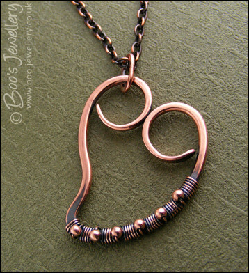 Curly antiqued copper heart wrapped with beads