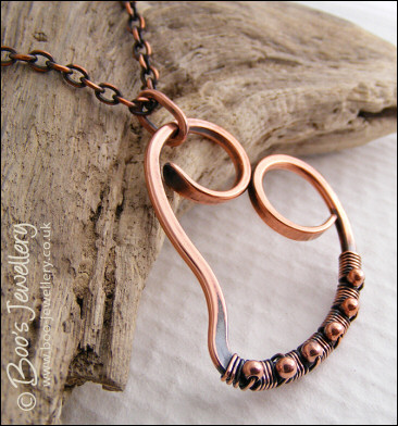 Curly antiqued copper heart wrapped with beads