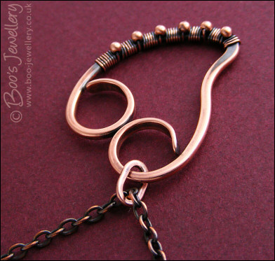 Curly antiqued copper heart wrapped with beads