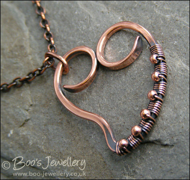 Curly antiqued copper heart wrapped with beads