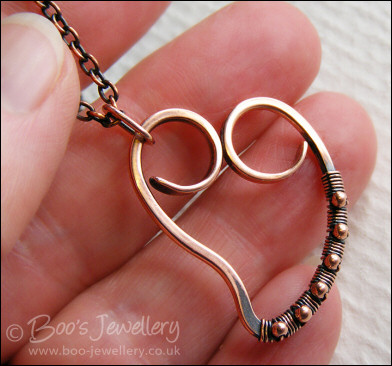 Curly antiqued copper heart wrapped with beads