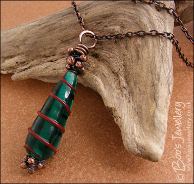 Antiqued copper and green glass pendant