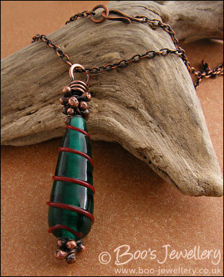 Antiqued copper and green glass pendant