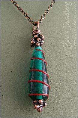 Antiqued copper and green glass pendant