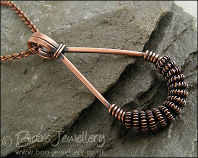 Antiqued copper teardrop pendant with spiralled coils