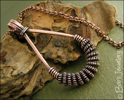 Antiqued copper teardrop pendant with spiralled coils