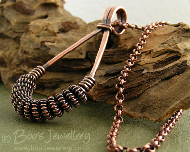 Antiqued copper teardrop pendant with spiralled coils