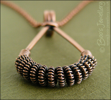 Antiqued copper teardrop pendant with spiralled coils