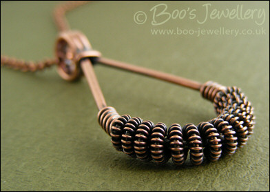 Antiqued copper teardrop pendant with spiralled coils