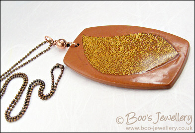 Polymer clay pendant inlaid with tiny gold balls