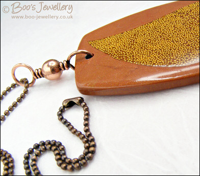 Polymer clay pendant inlaid with tiny gold balls