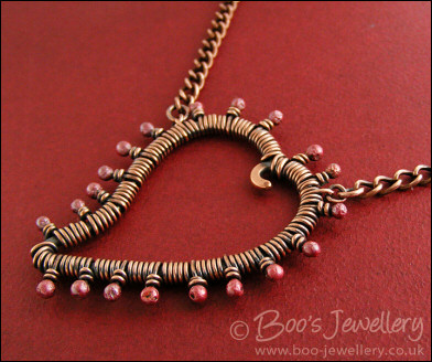 Antiqued copper heart necklace wire wrapped with rosy buds