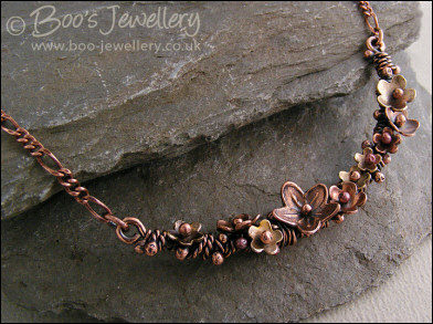 Copper and bronze necklace wrapped with buds and flowers